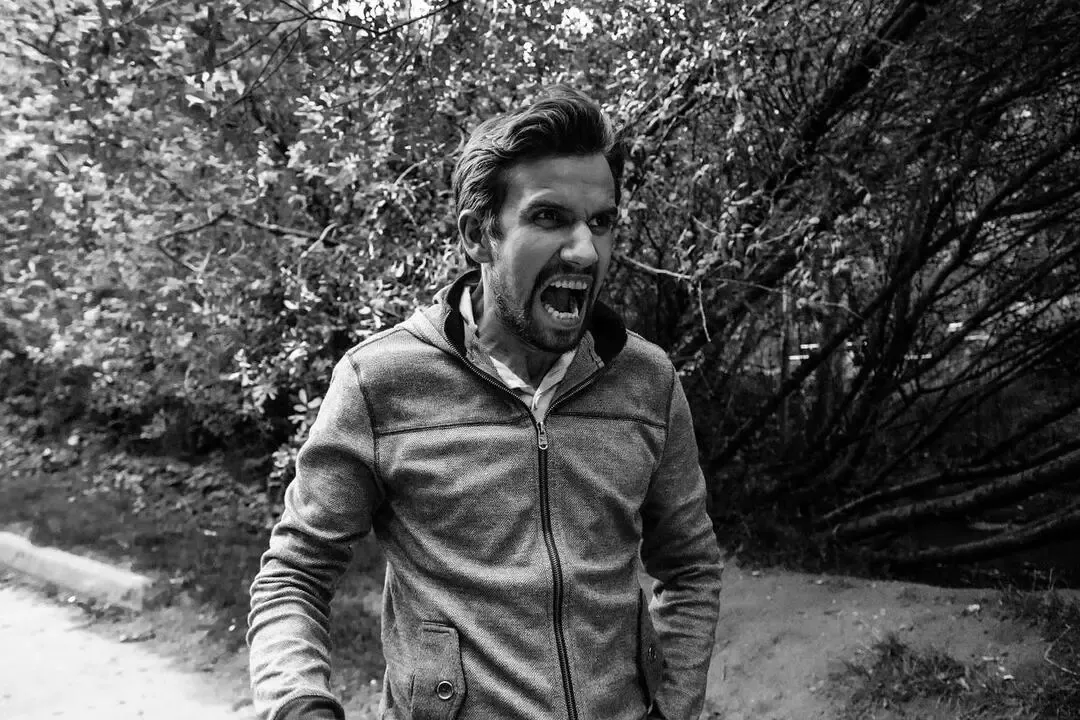 A man shouting outdoors, photographed in black and white